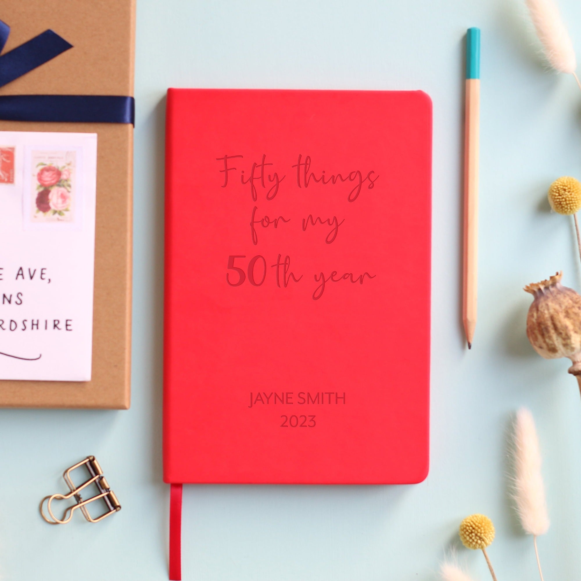 Red Vegan leather notebook with personalised laser engraving on the cover saying 50 things for my 50th year