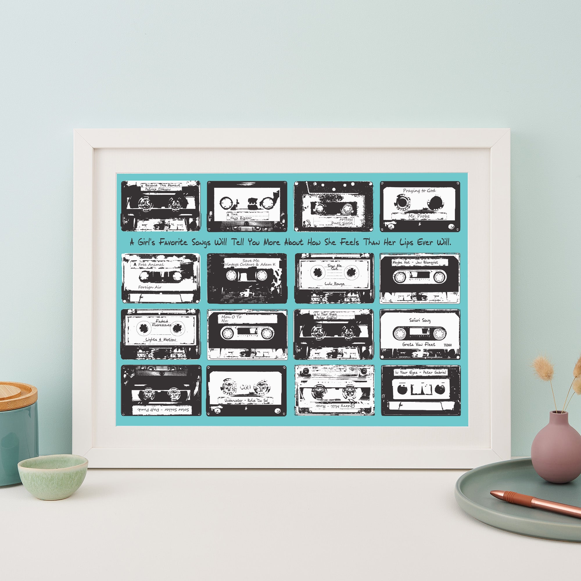 Framed print with 16 monochrome music cassettes on a white background and personalised text. 
