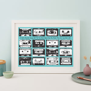 Framed print with 16 monochrome music cassettes on a turquoise background and personalised text.