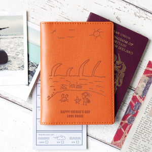 Orange passport wallet with child's drawing