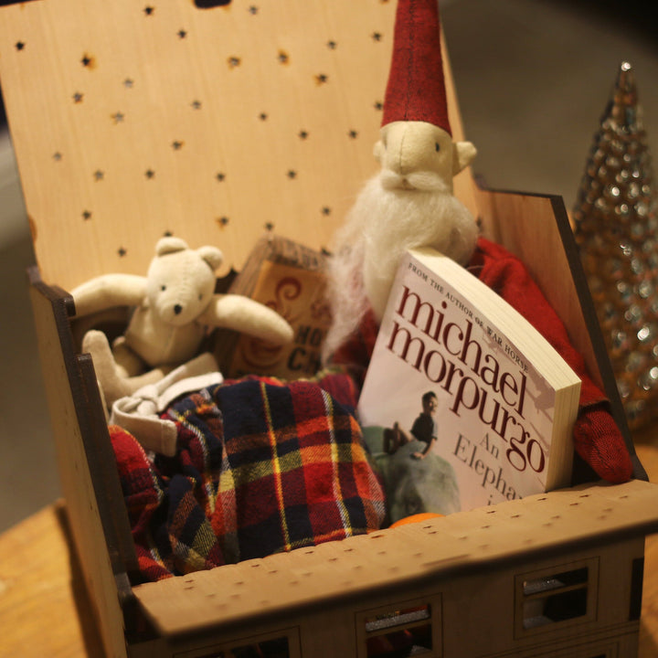 Personalised Wooden box house with the roof open, showing Christmas presents inside.