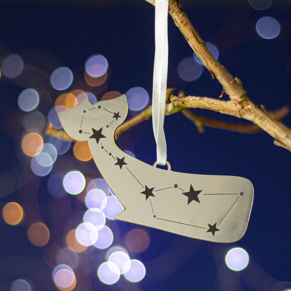 Silver metallic christmas tree decoration of a whale engraved with a constellation of stars