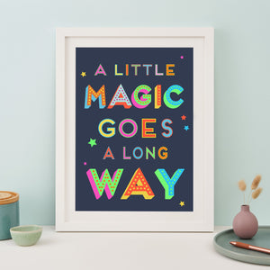 Navy print with the text "A little magic goes a long way" printed in rainbow colours