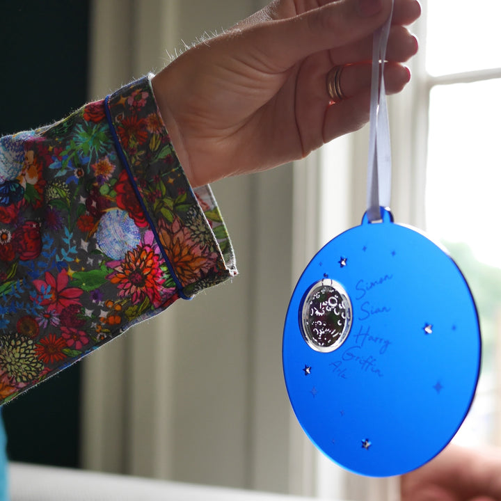 Dark blue frosted acrylic Christmas decoration with moon and stars design.