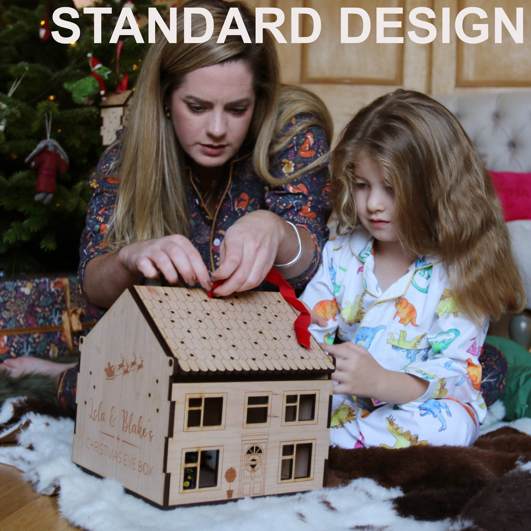 Personalised Wooden box house being opened by mother and daughter on Christmas morning.