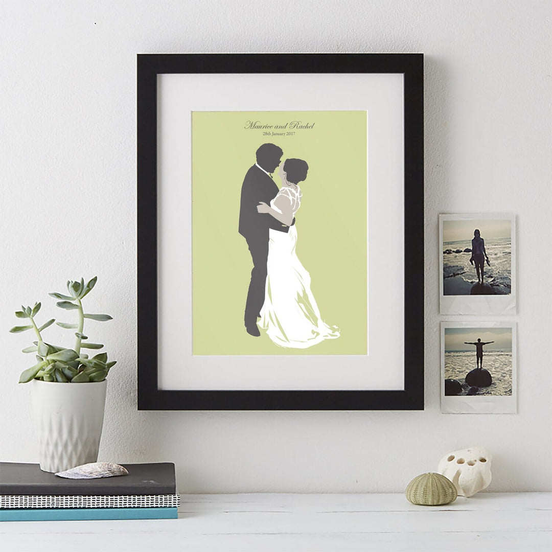 A wedding silhouette portrait in a black frame. The bride and groom are dancing on a light green background. Their names and wedding date are written at the top.