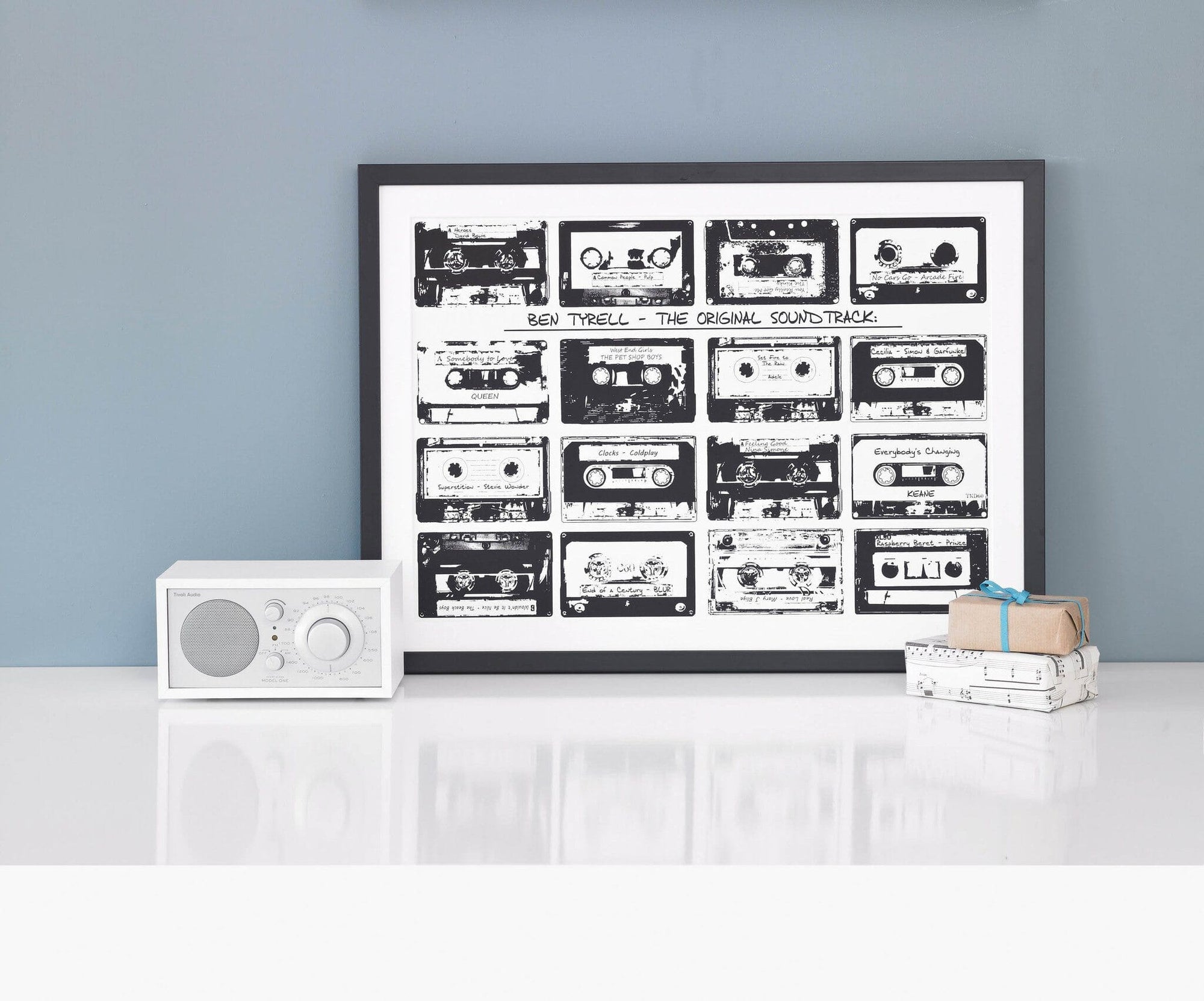 Framed print with 16 monochrome music cassettes on a white background and personalised text.