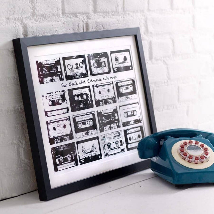 Framed print with 16 monochrome music cassettes on a white background and personalised text.