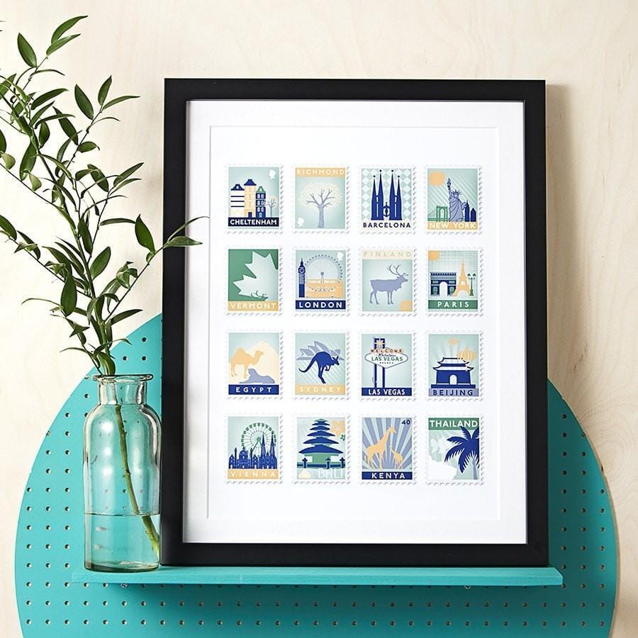 White framed print with 25 blue, red and yellow toned stamp designs on a white background.
