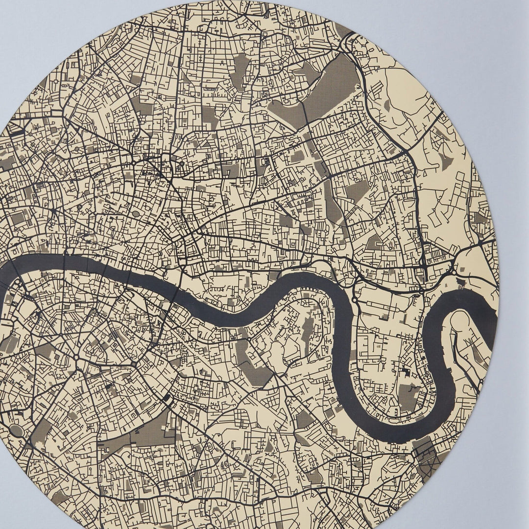 Close-up of a circular map of London with the Thames River winding through it, displayed in sepia tones. The map shows detailed street patterns and building outlines.