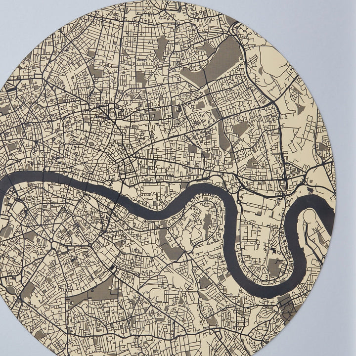 Close-up of a circular map of London with the Thames River winding through it, displayed in sepia tones. The map shows detailed street patterns and building outlines.