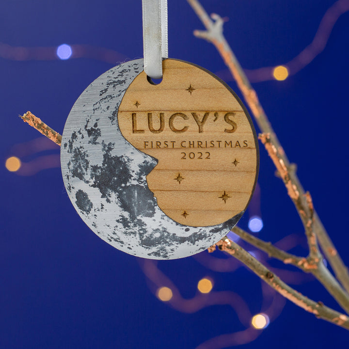 Personalised child's first xmas Christmas tree ornament. Wooden round decoration with a silver crescent  moon and personalised text.