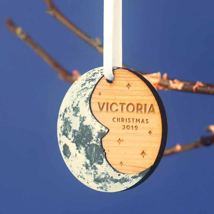 Custom engraved moon bauble, rustic cedar wood with silver half-moon design.