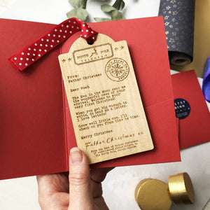 Luggage tag shaped Wooden decoration engraved with a typed message from Father Christmas  in a red gift card