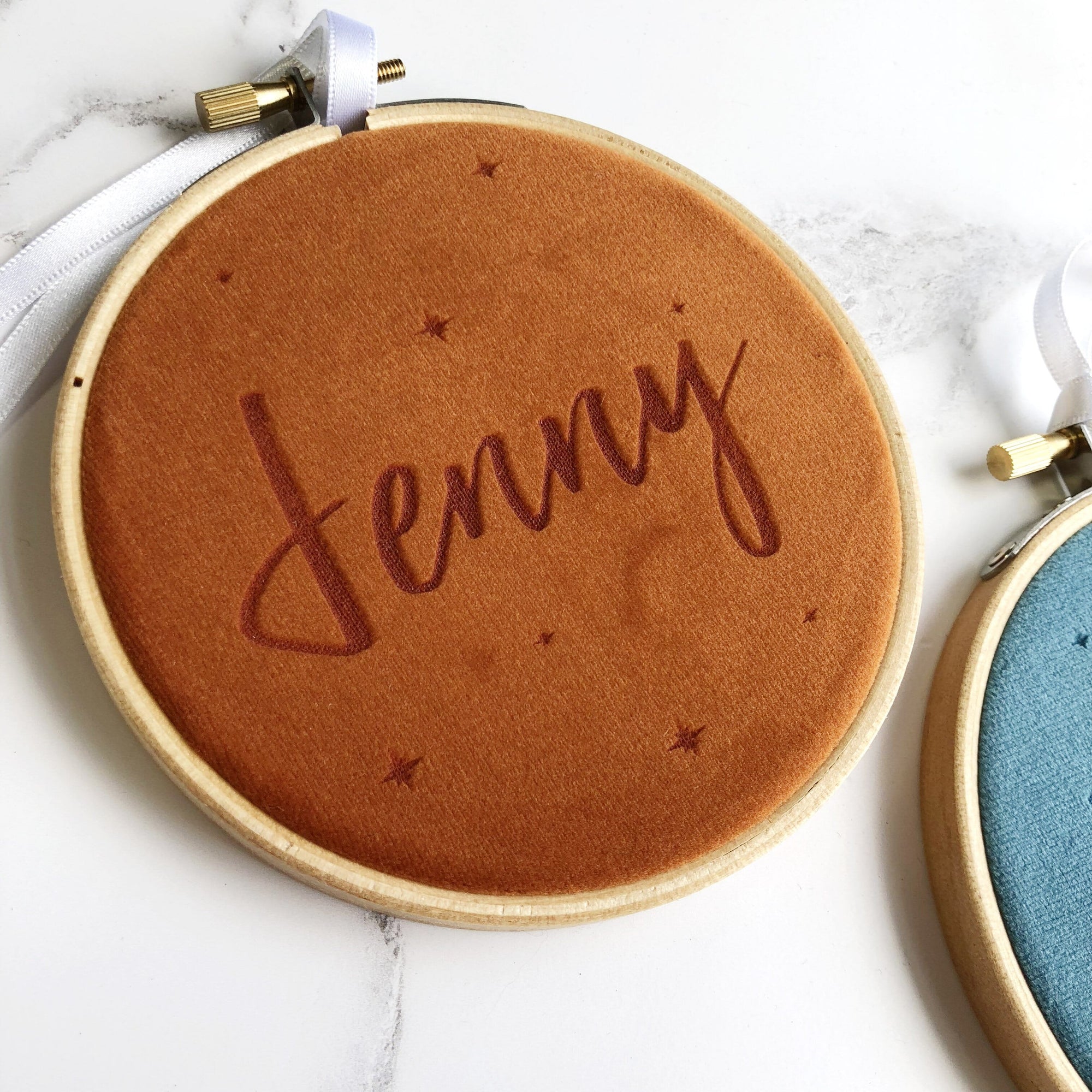 Velvet fabric in an embroidery hoop engraved with a name