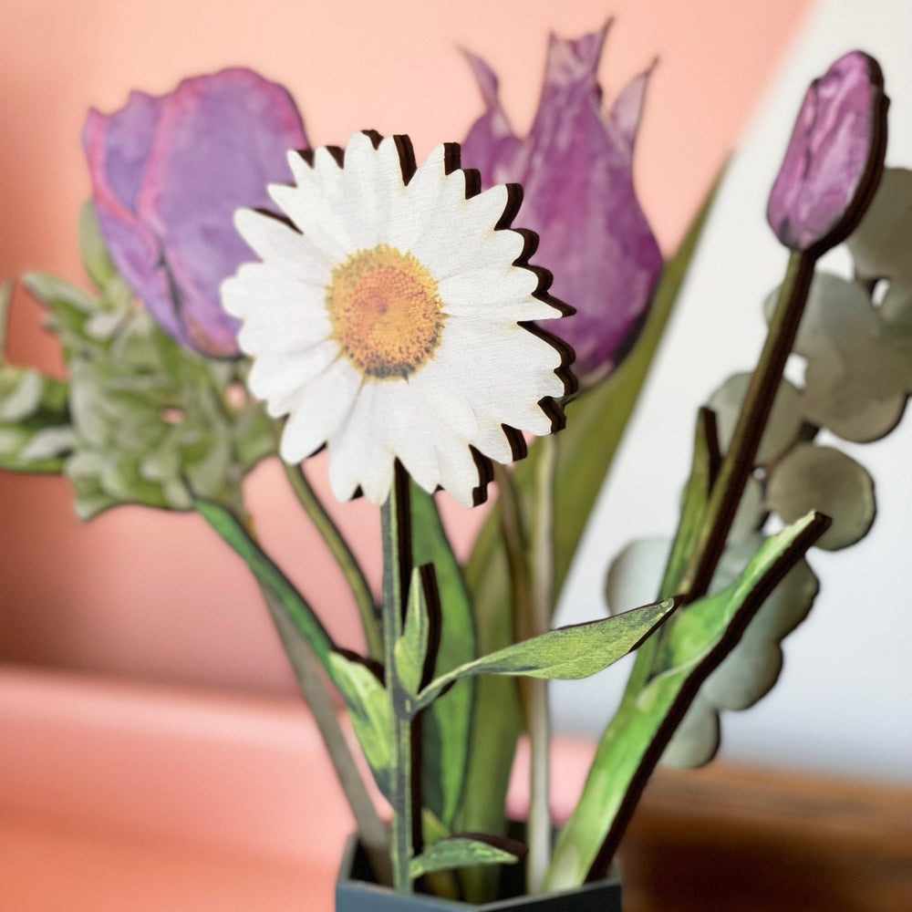 Bouquet of coloured wooden flowers including a daisy, tulips and greenery