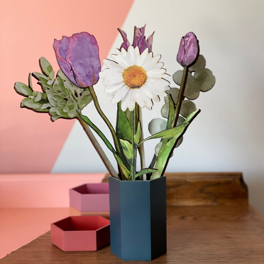 Bouquet of coloured wooden flowers including a daisy, tulips and greenery