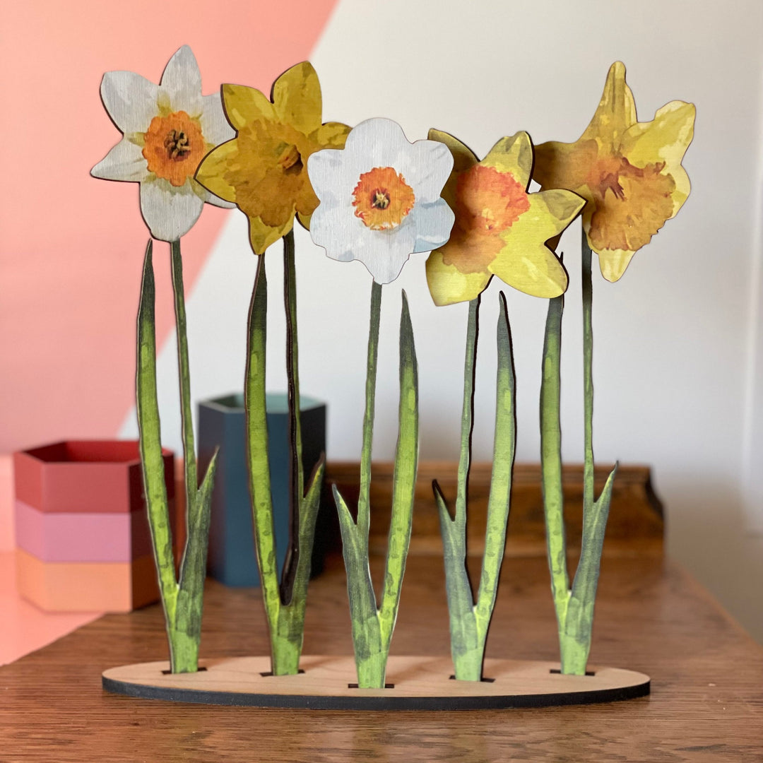 Assortment of different wooden coloured daffodils displayed on a stand