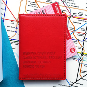 Red travel card holder engraved with some London Tube station names