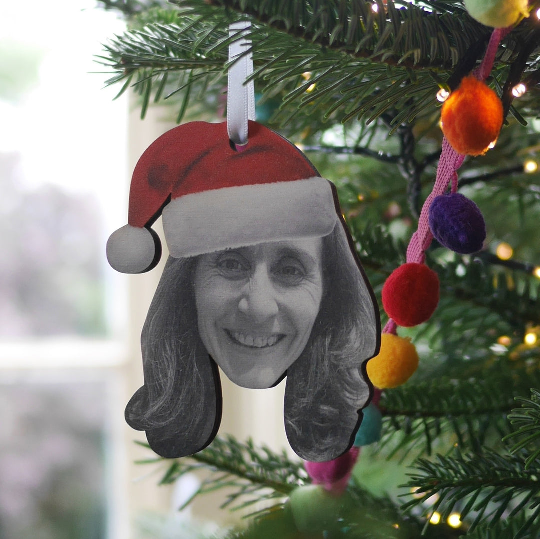 Personalised wooden Christmas bauble with woman wearing Santa hat.