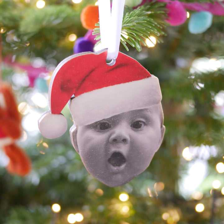 Personalised rustic Christmas ornament with toddler in Santa hat illustration.